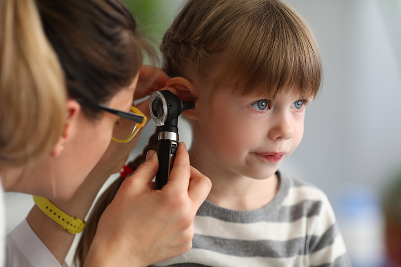 Child receiving Health screening exam