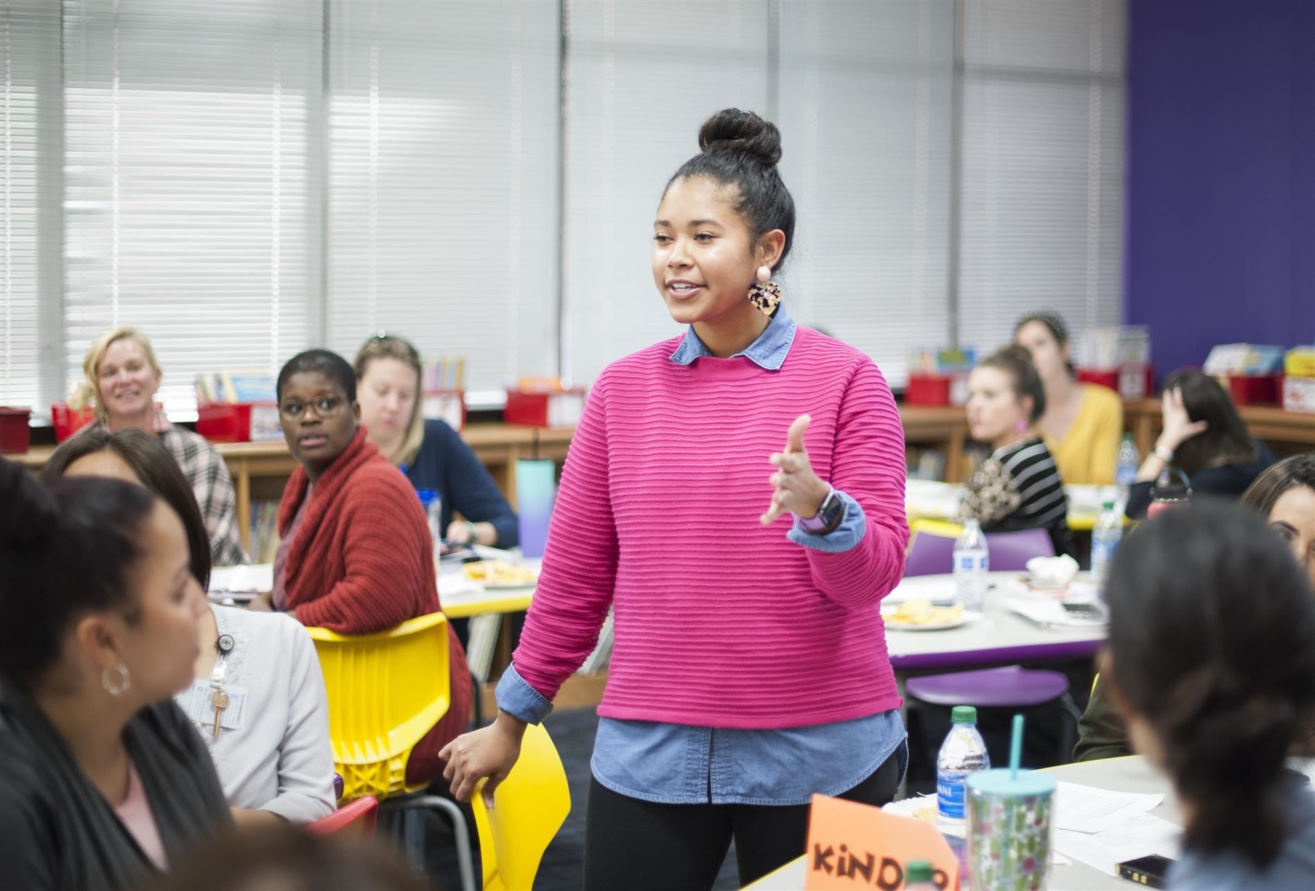 Teacher speaking to peers