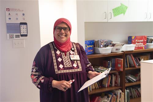 Teacher shopping at the CORE Store, shelves of free books in the background