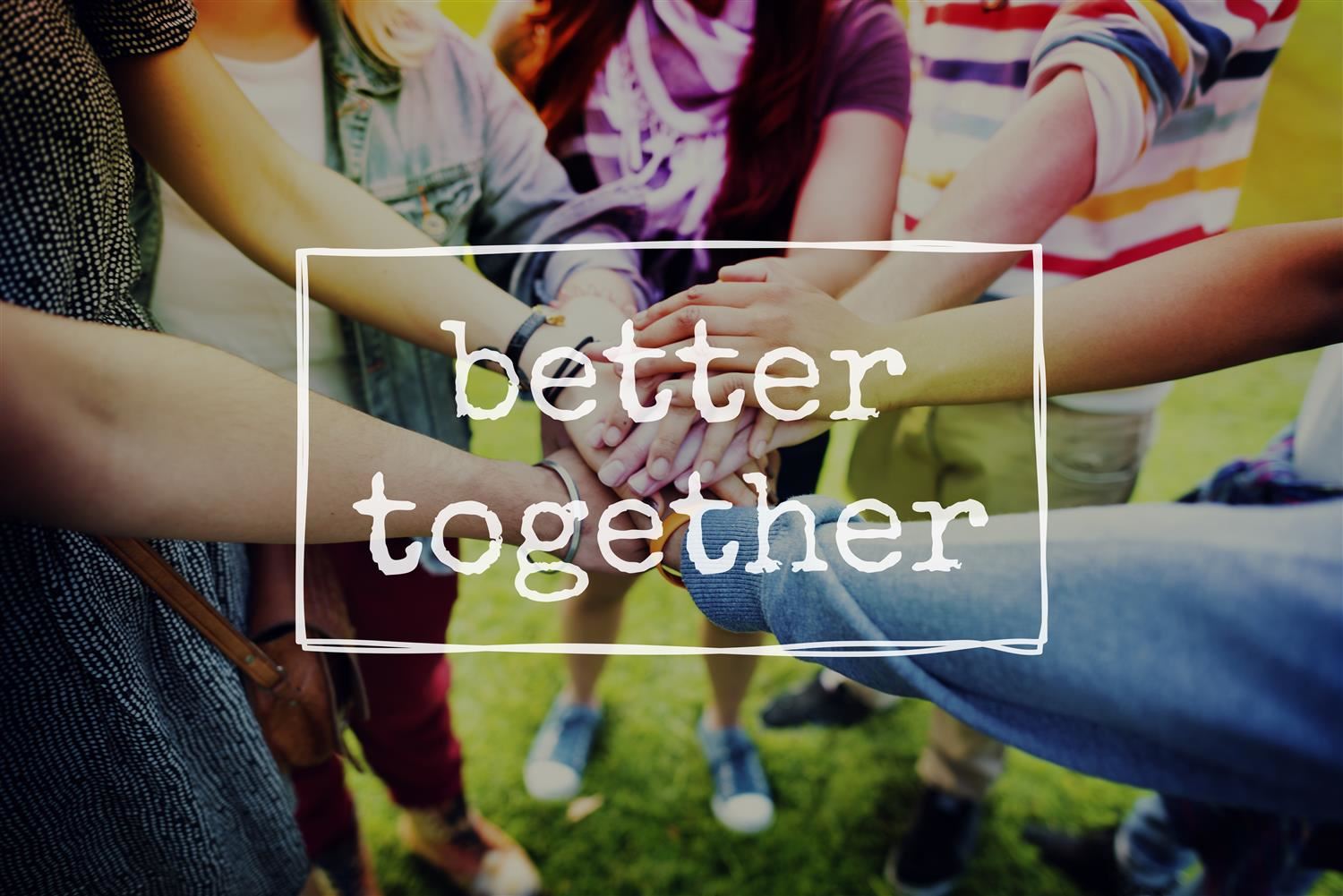Better together - group of people with hands stacked on top of each other Better together - group of people with hands stacked on top of each other