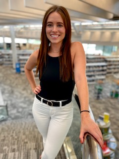 Kelli Self standing in a library 