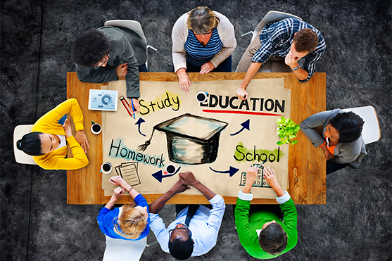 Group around a table with drawing of graduation cap, study, education, homework, school