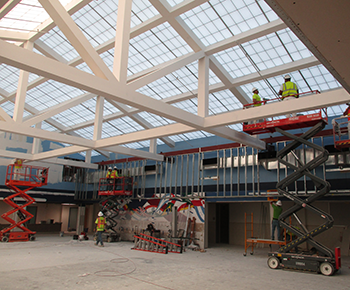  School site construction - workers on lifts - interior of building