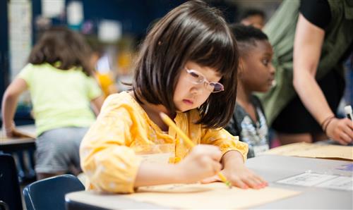 Girl writing in class 