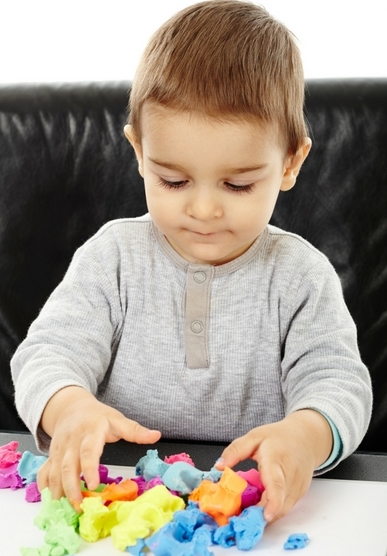 Student playing with play dough 