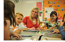 Teacher reading with a group of students 