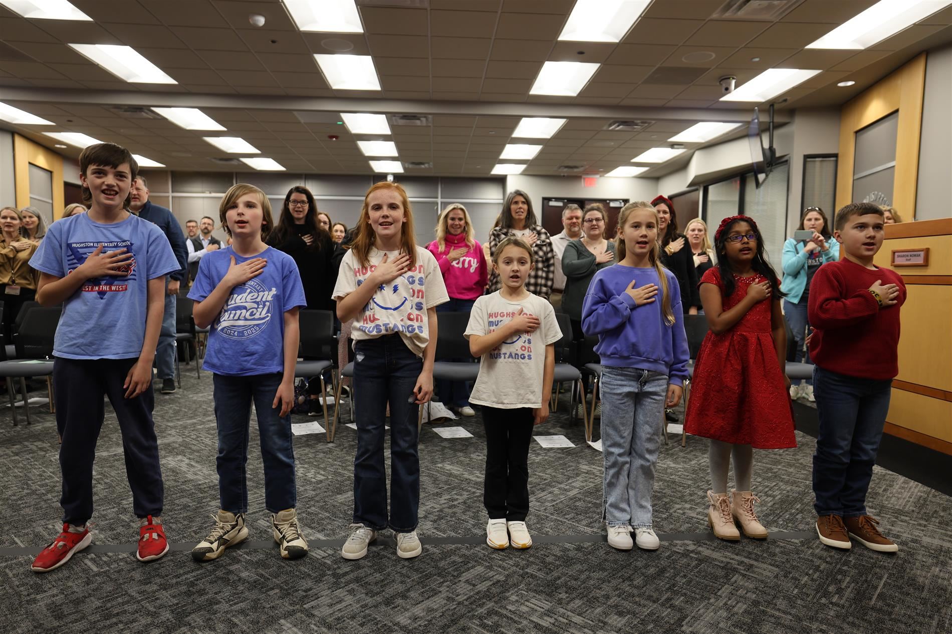 students from hughston elementary reciting the pledges of allegiance.