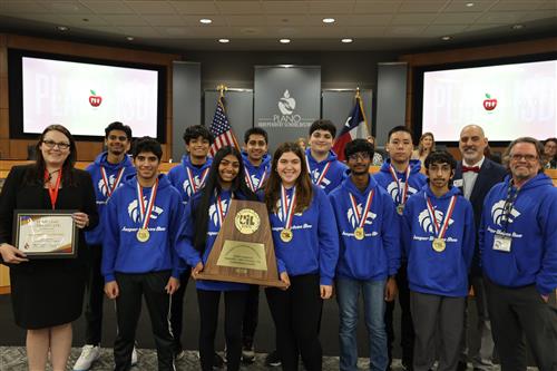 jasper robotics team holding championship trophy and board certificate