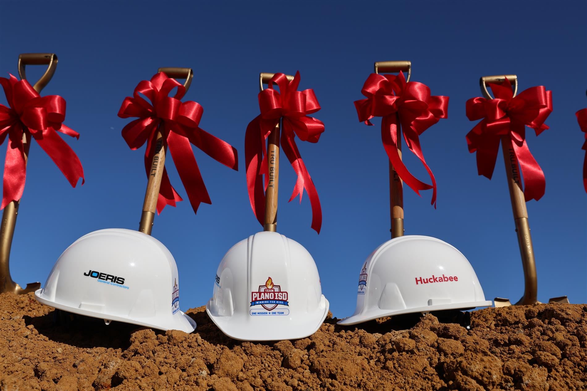 hard hats and shovels with bows.