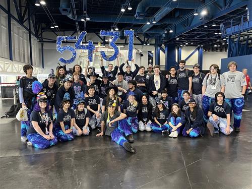 Academy High School Robotics Team with 5431 in blue signage letters behind them