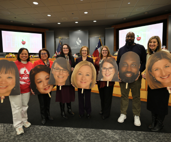  Board members with large foam board cutouts of themselves in celebration of Board Recognition Month