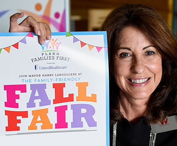  Families First Fall Fair smiling woman holding poster