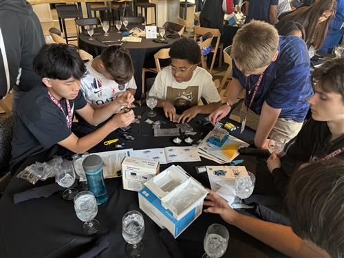 A group of students assembling a solar science station 