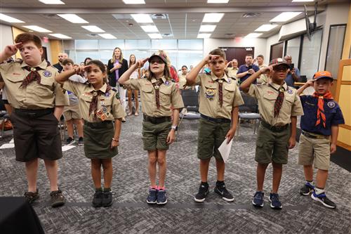 six individuals from boy scout troop 200 lead the Pledge of Allegiance to the United States