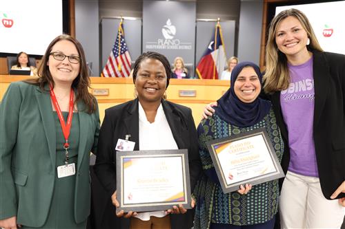 four individuals in front of the Plano ISD Board of Trustees dais