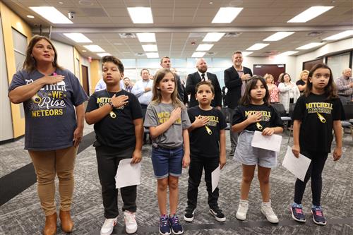 students from mitchell elementary performing the pledges of allegiance
