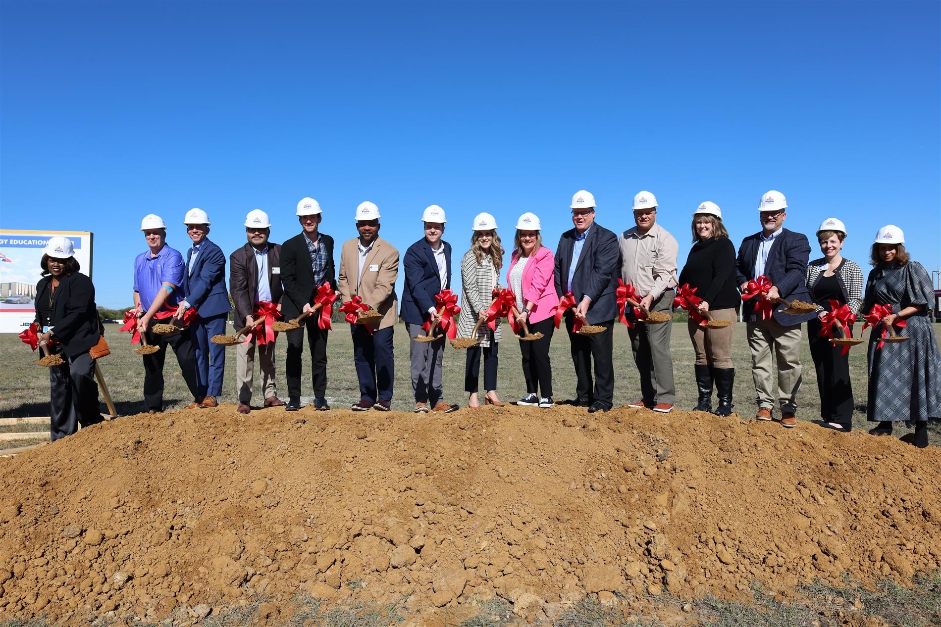 District executive leadership team tossing dirt for groundbreaking ceremony.