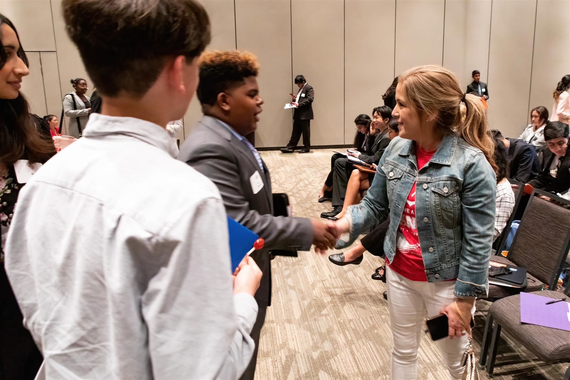 superintendent williams shaking hands and speaking to students