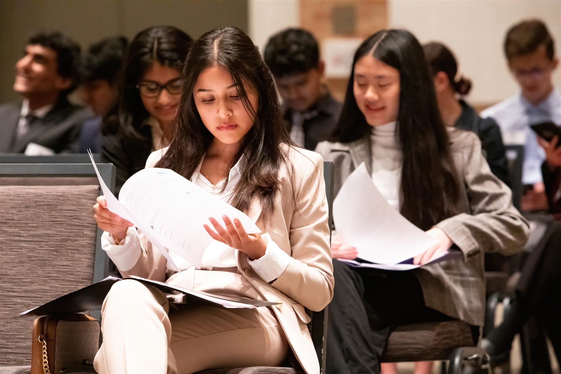 students sitting and looking over papers