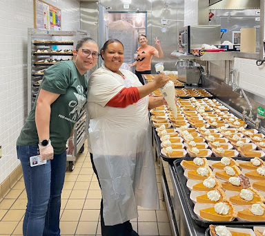 Cafeteria workers preparing meal