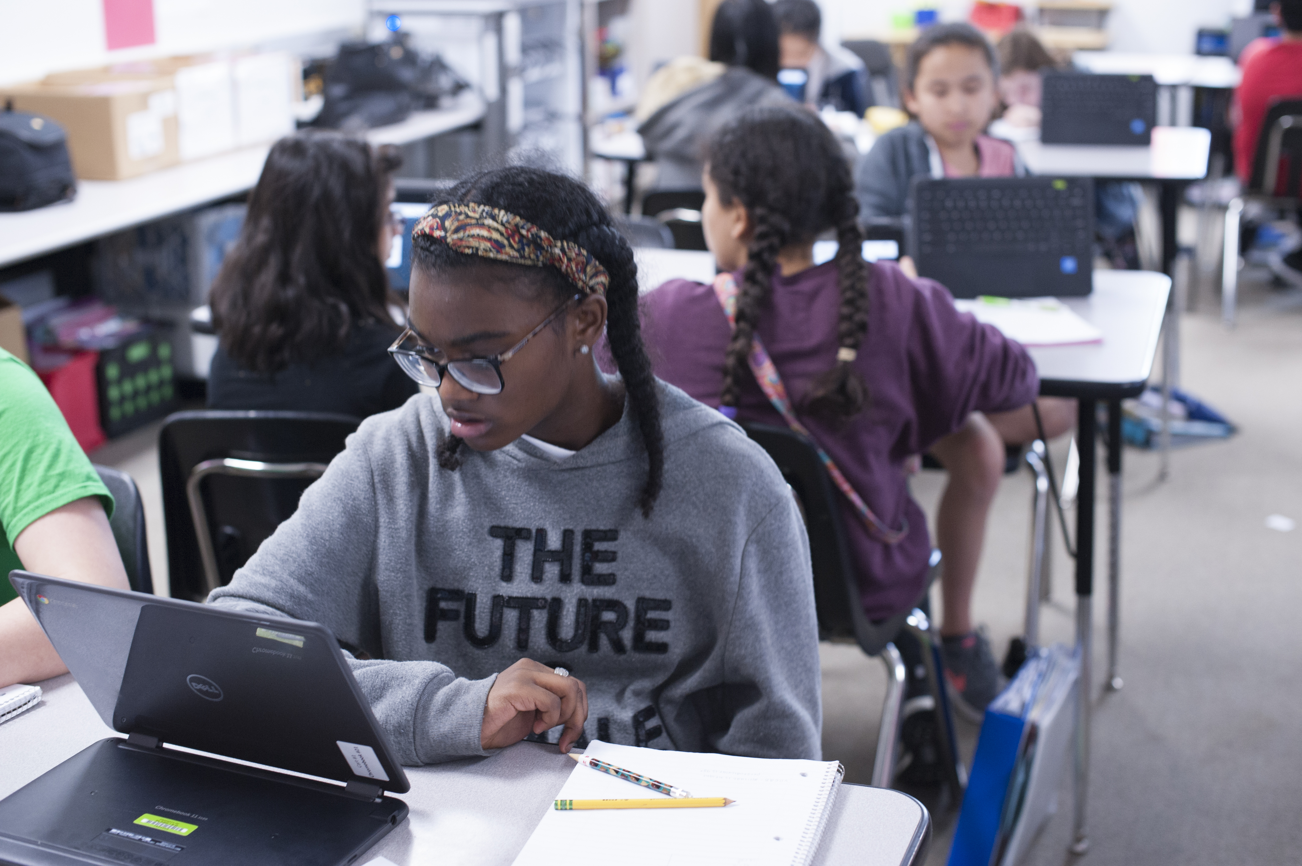 Student at desk with Chrome book 