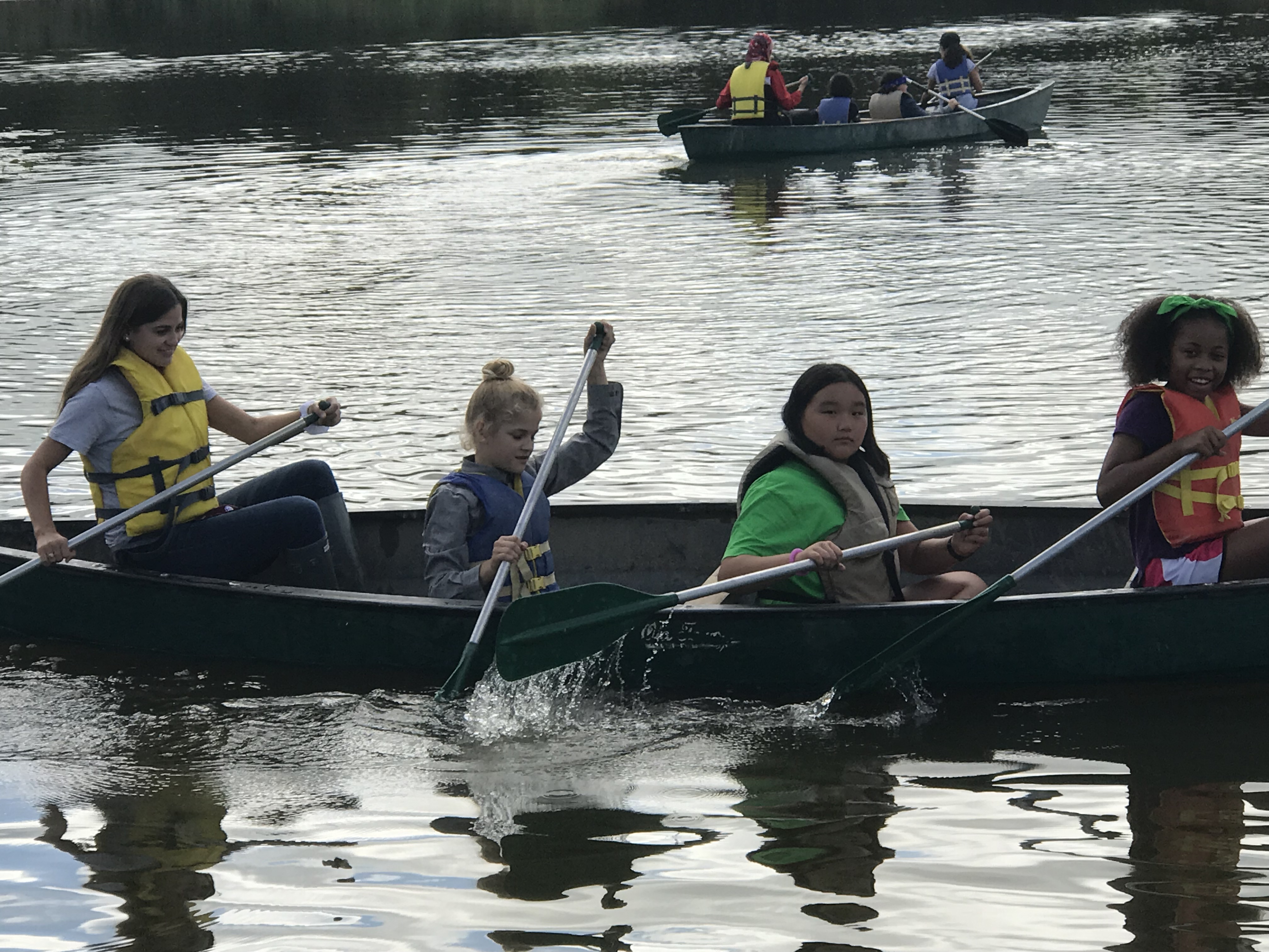 Gullege girls paddling canoe 