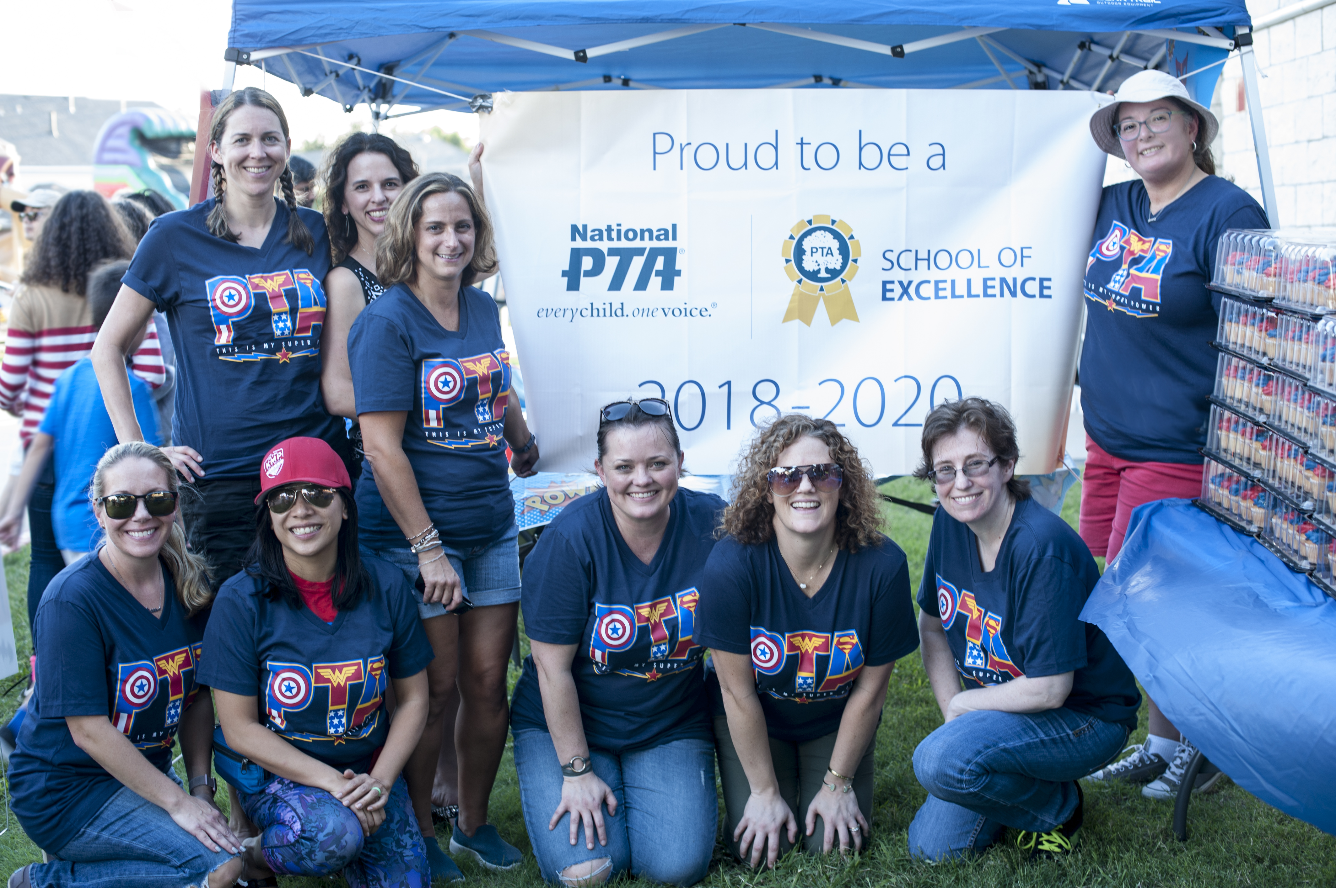 Haun PTA president and officers with sign Proud to be School of Excellence 