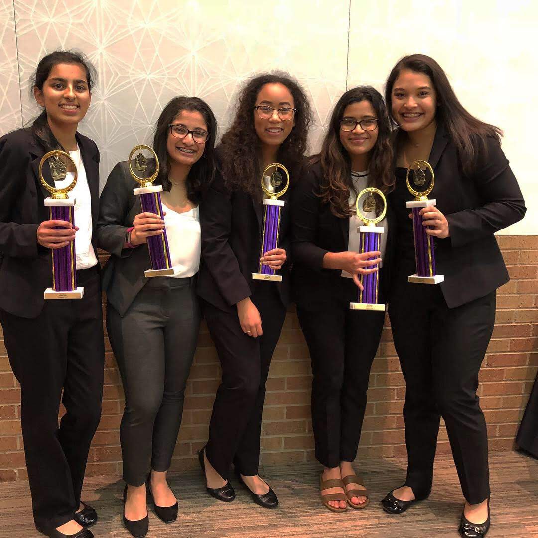 Female students with their trophies 