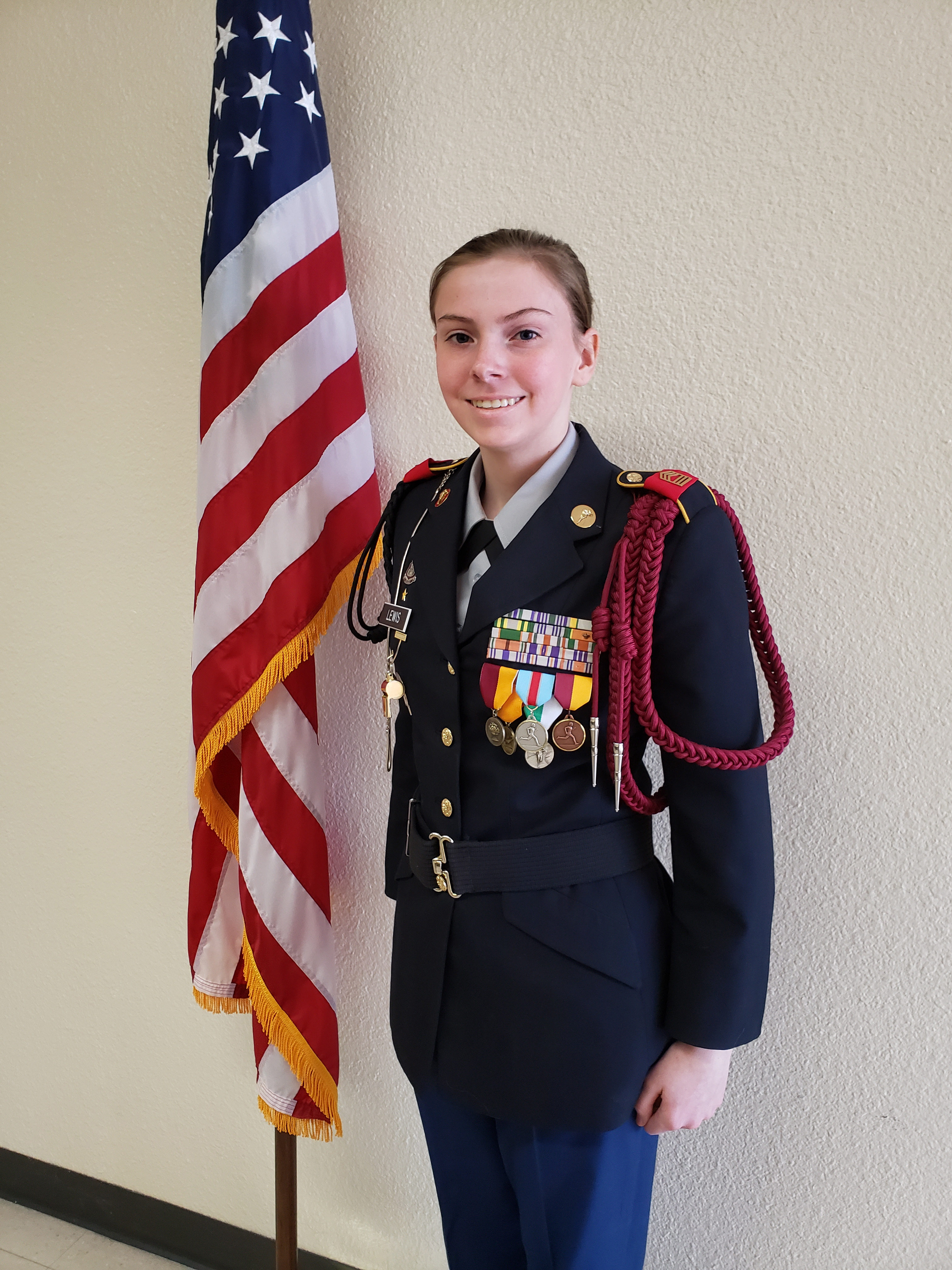 Cadet First Sergeant Landry Lewis with American flag 