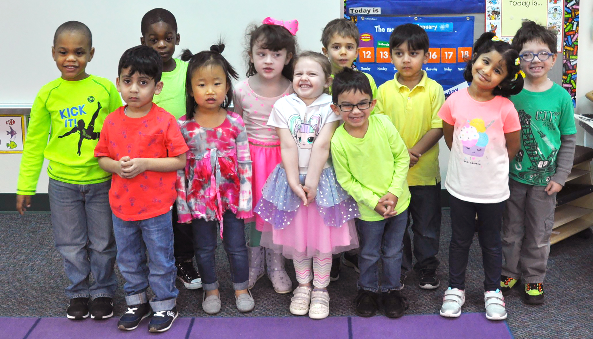 Group of Pearson PreK students in colorful neon clothing 