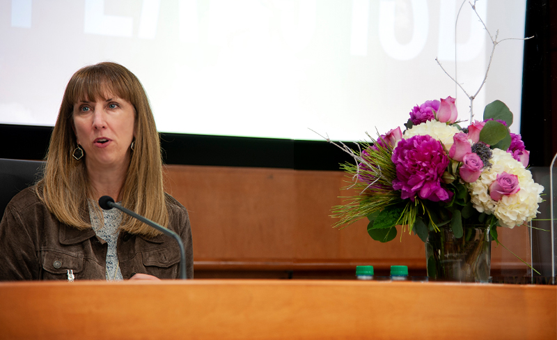 Sara Bonser at Board Dais w/flowers 