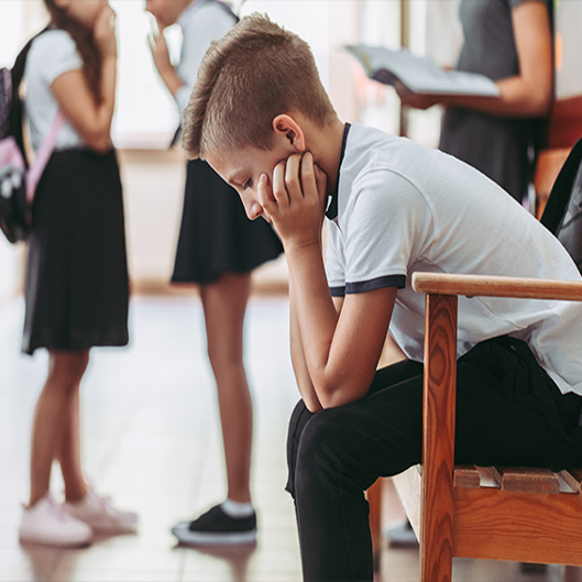 Male student holding head down Male student holding head down