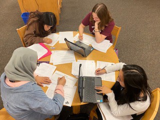 Students working on a project together in the library