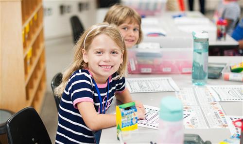 Girls coloring in classroom  