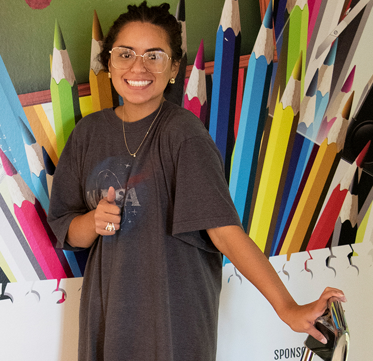  Teacher shopping at CORE Store giving thumbs up