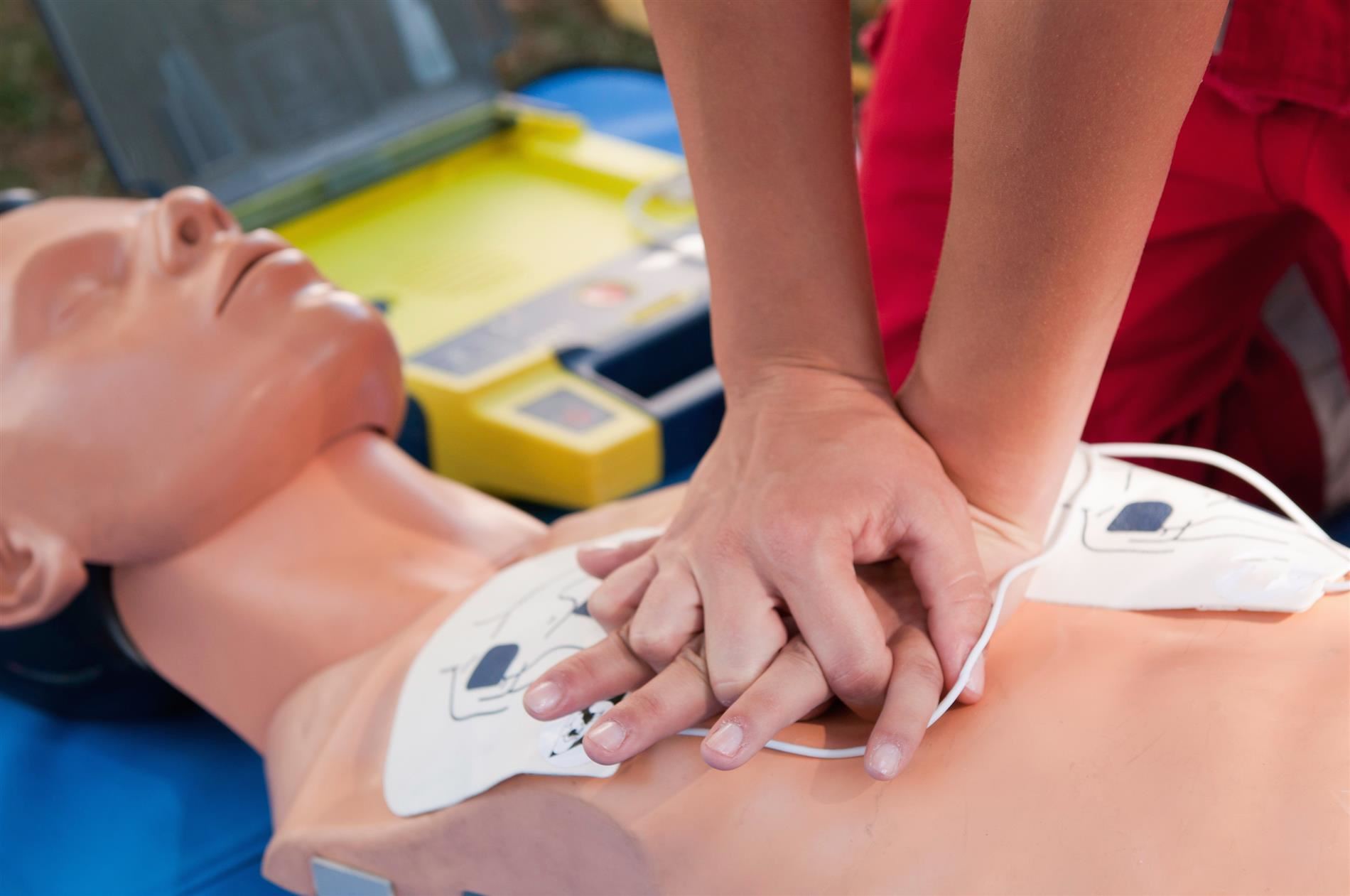 student practicing cpr on plastic dummy