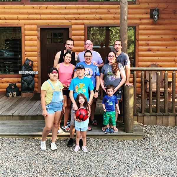 family on the porch of a cabin